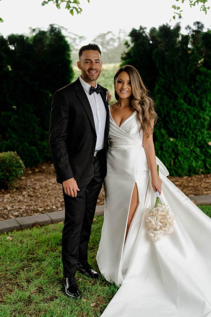 Bridal couple smiling in garden