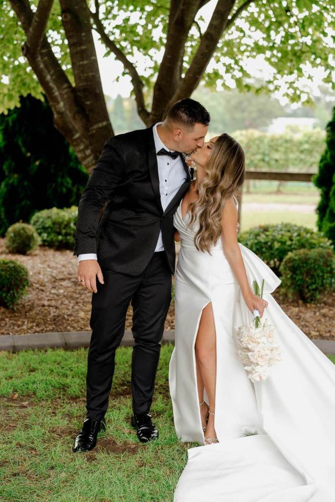 Married couple kissing in garden