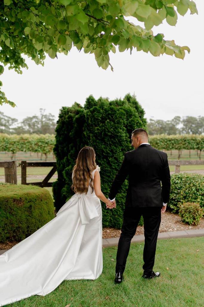 Married couple walking in garden Centennial Vineyards