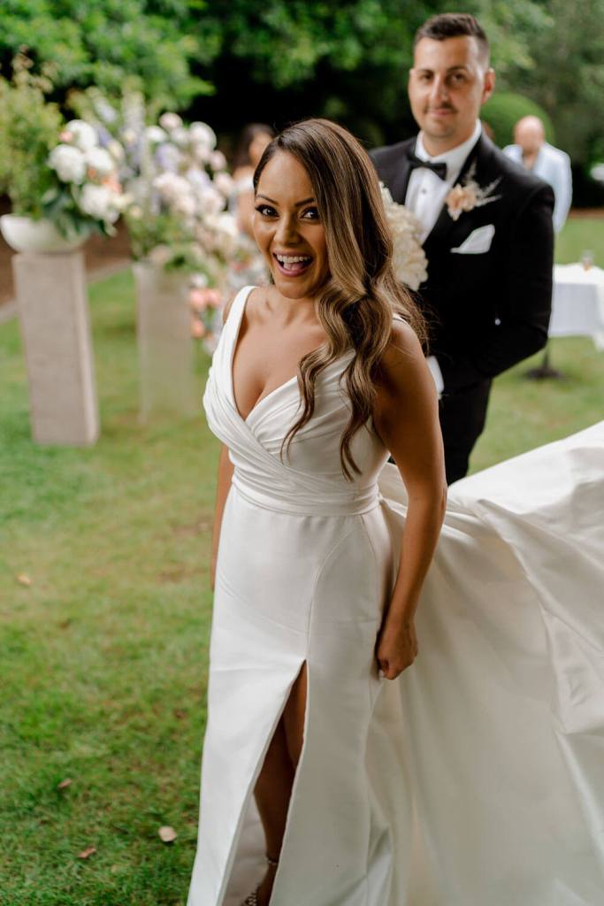 Bride walking in garden Centennial Vineyards