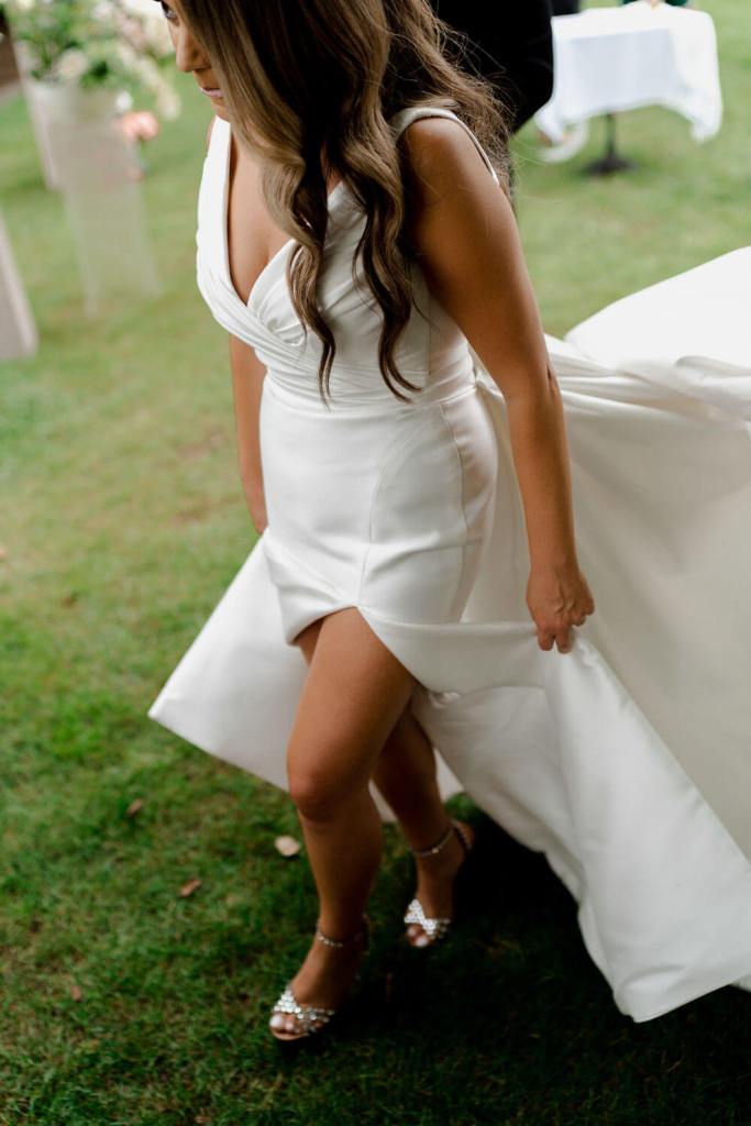 Bride walking in garden Centennial Vineyards