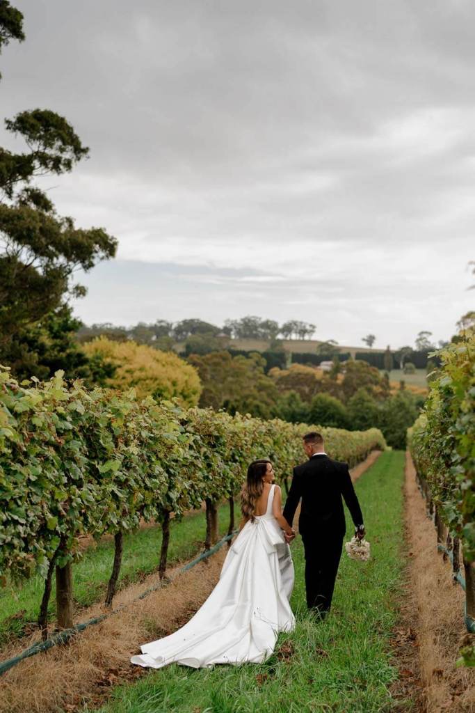 bride and groom walking in Centennial Vineyards