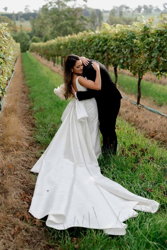 Bride and groom kissing in Centennial Vinyards Bowral