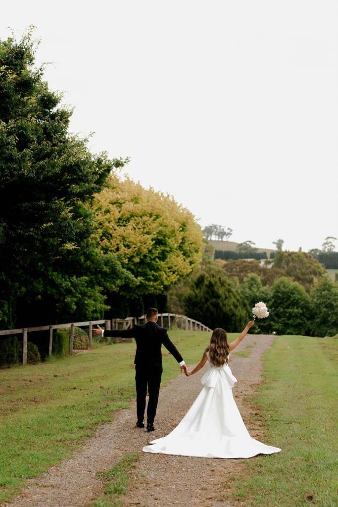 Bride and groom cheering and walking
