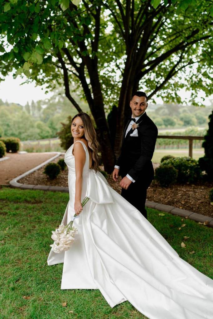 Bride and groom smiling backwards at camera