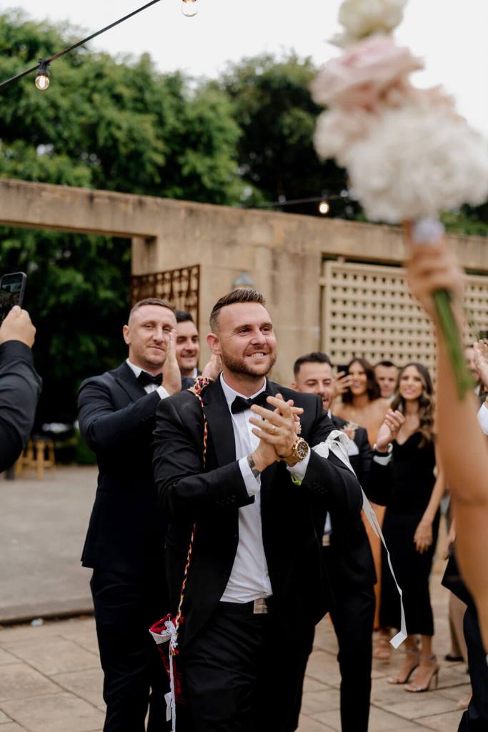 Groomsman smiling and dancing