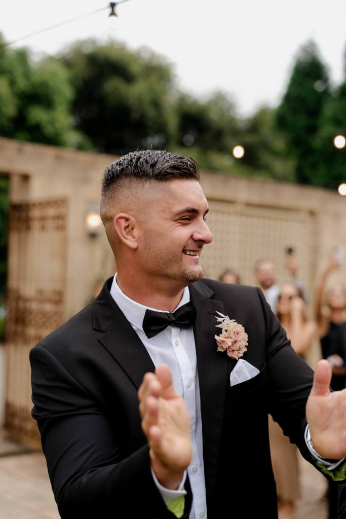 Groomsman smiling and dancing