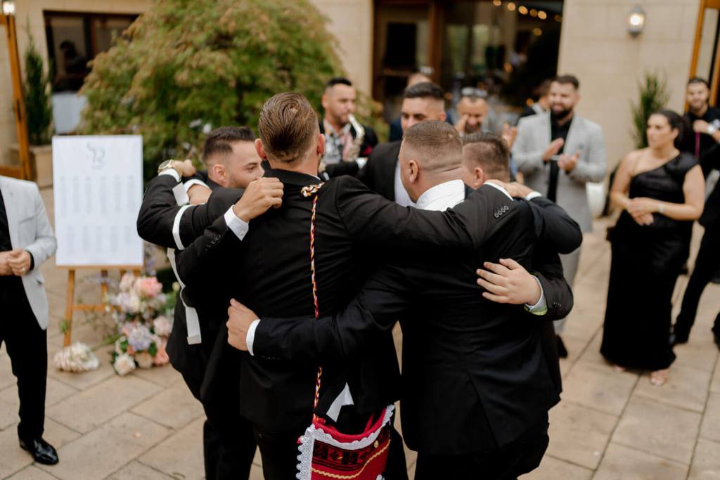 Men hugging in circle