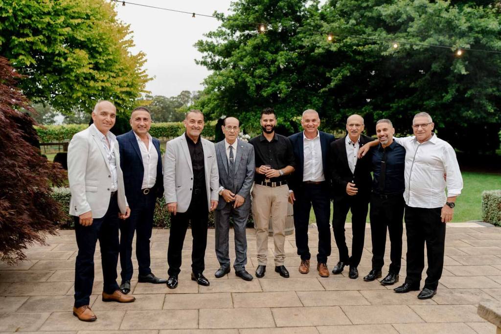 Group of men smiling at wedding