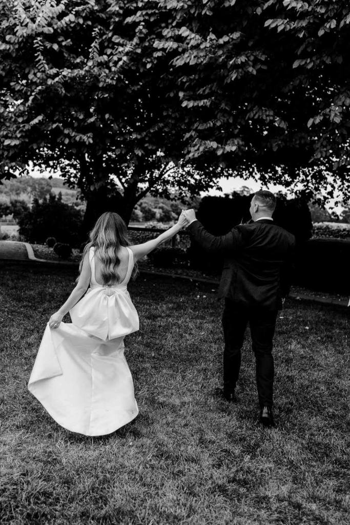 Bride and groom dancing in garden