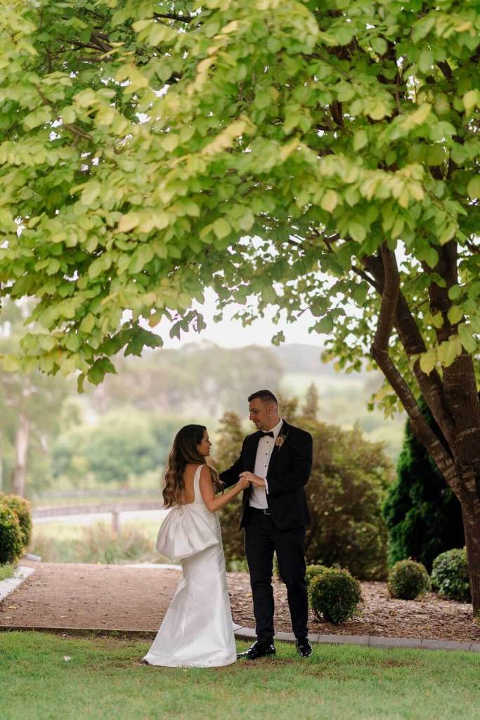 Bride and groom dancing in garden