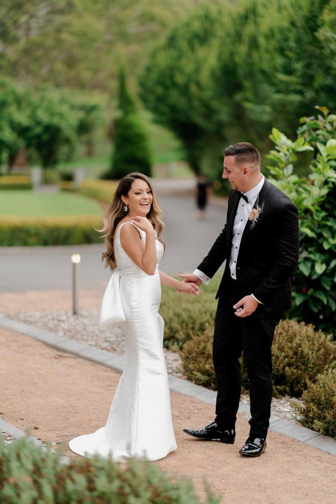 Bride and groom smiling at eachother