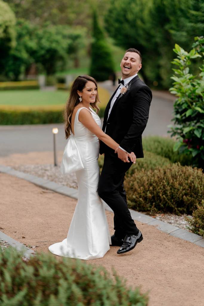 Bride and groom smiling at eachother