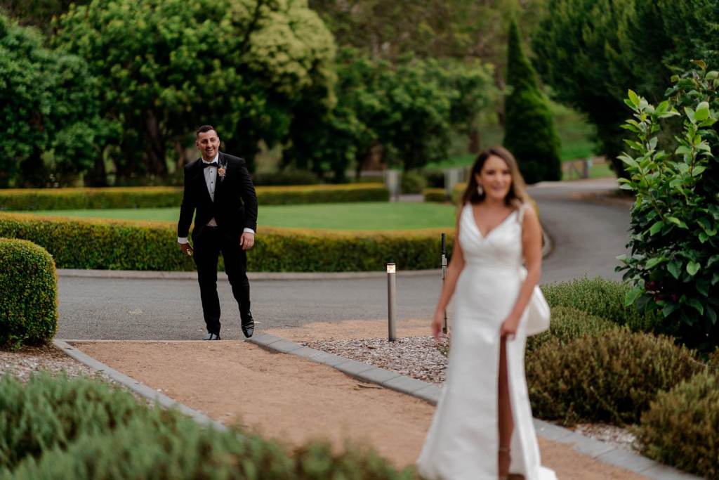 Bride and groom smiling at eachother