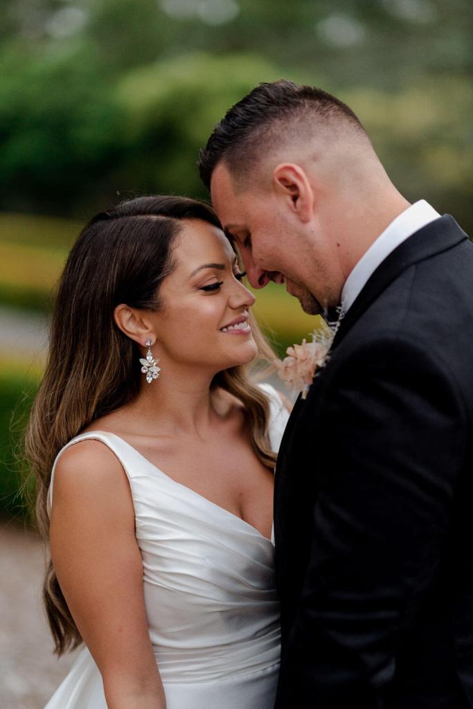 Bride and groom intimate touching
