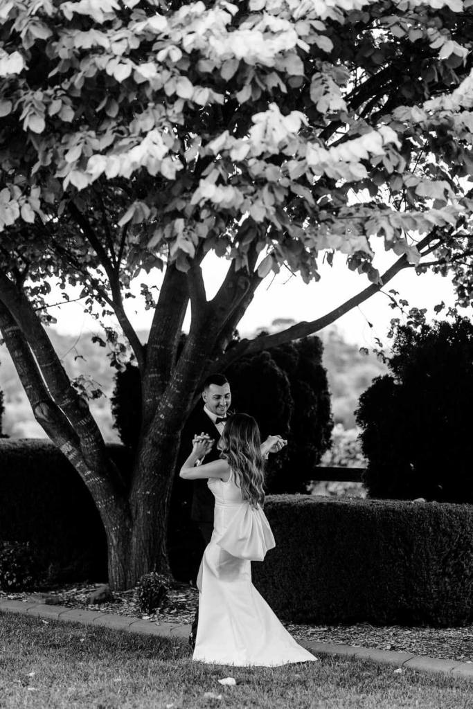 Bride and groom dancing in garden