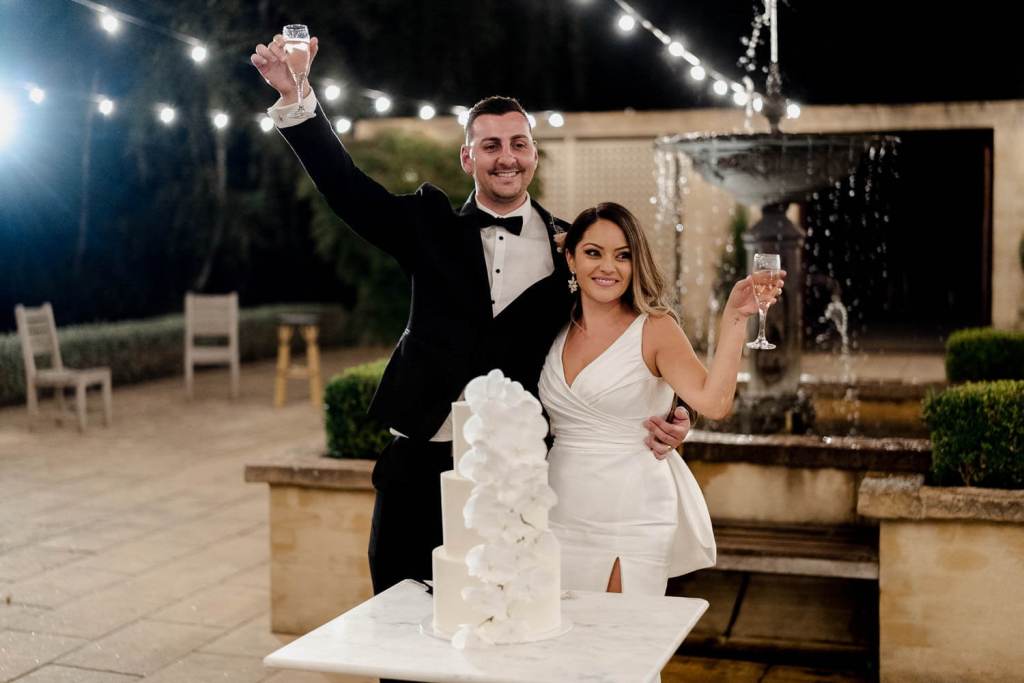 bride and groom cheersing guests