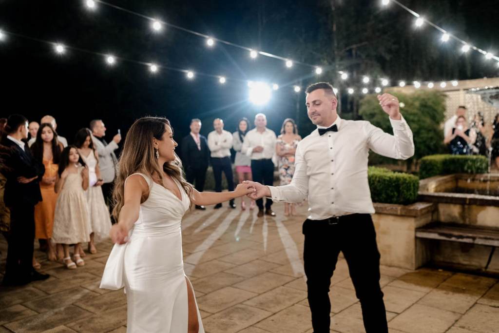 bride and groom laughing and dancing