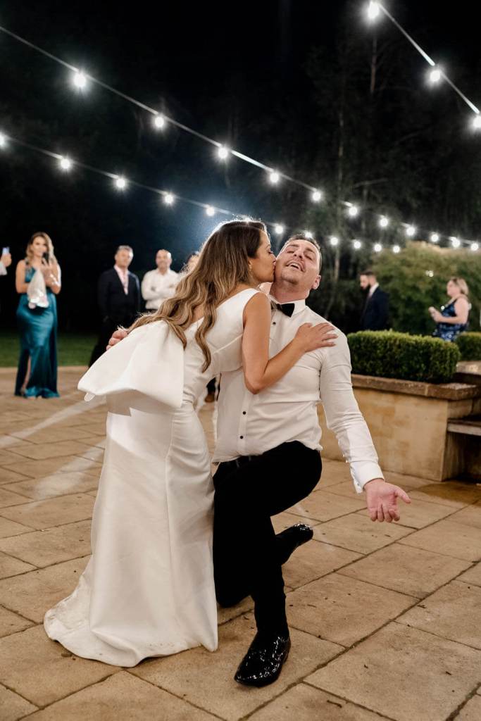 bride and groom kiss first dance