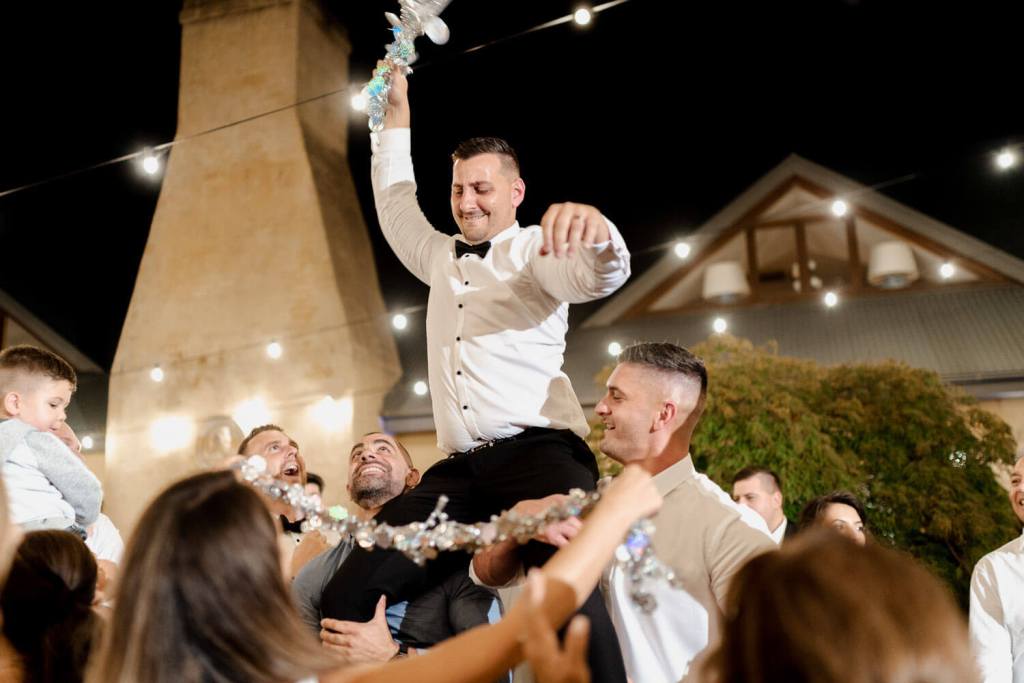 groom dancing on shoulders