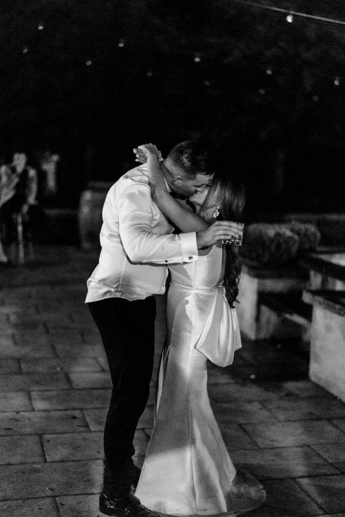 bride and groom kissing black and white