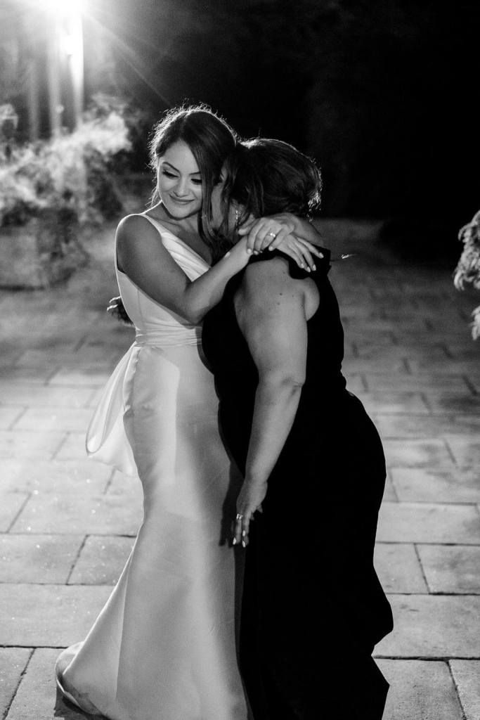 bride getting a kiss black and white