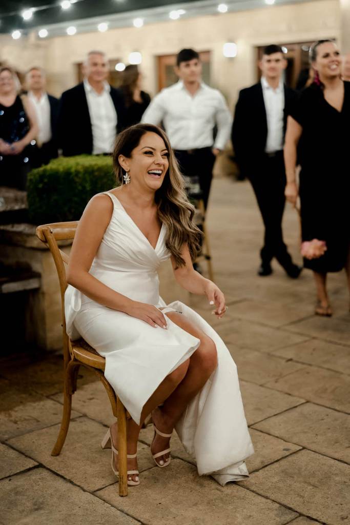bride laughing on chair