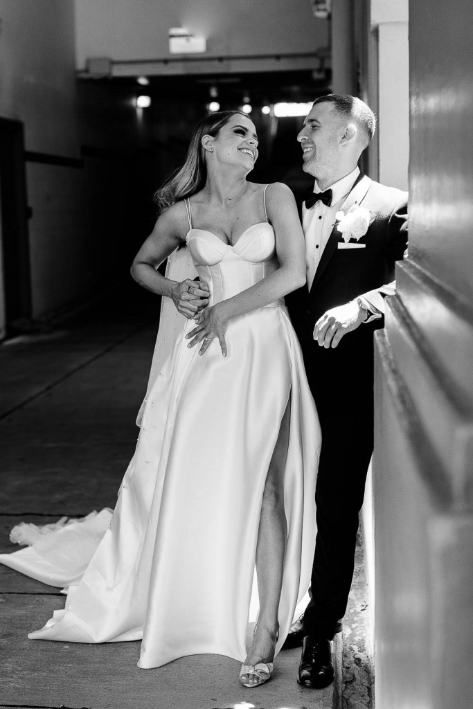 bride and groom smiling at eachother black and white