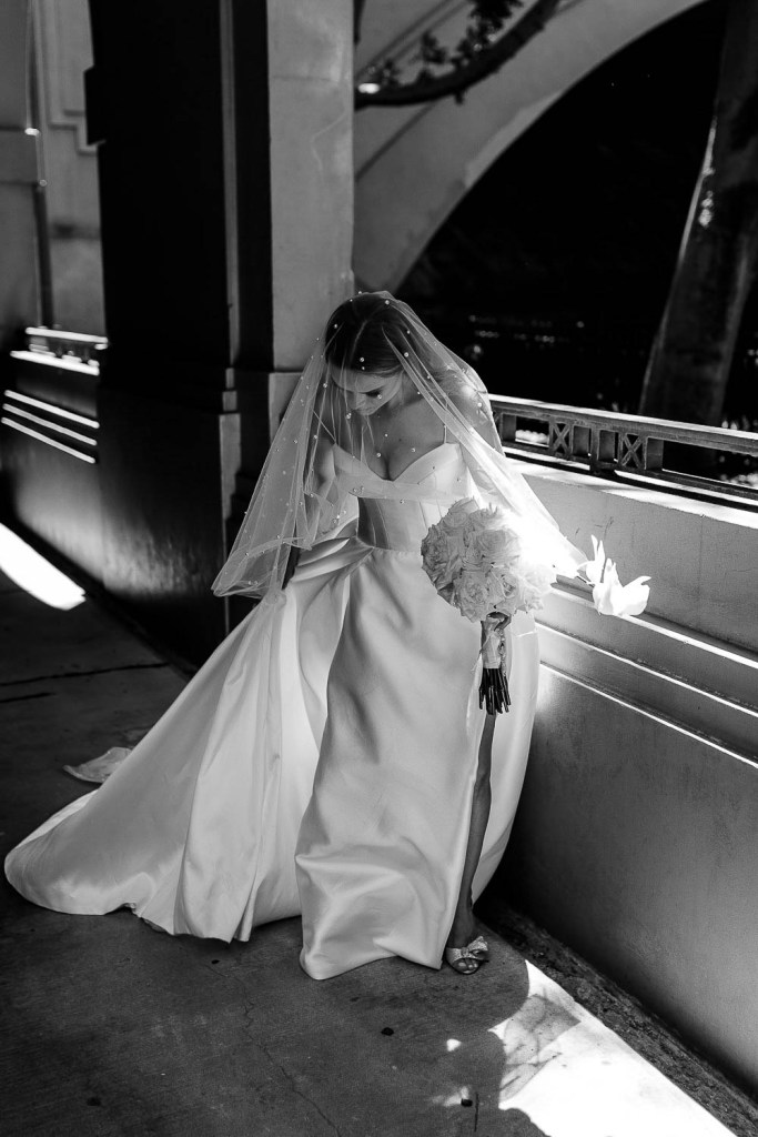 bride walking with flowly veil black and white