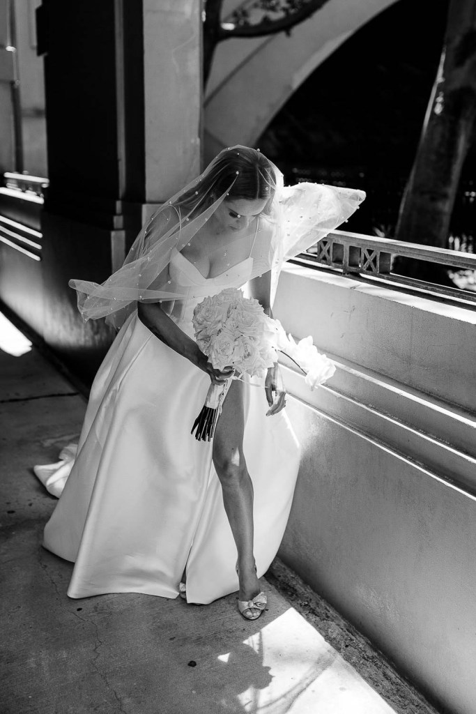 bride walking with flowly veil black and white