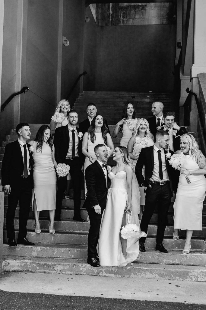 bridal party on stairs black and white
