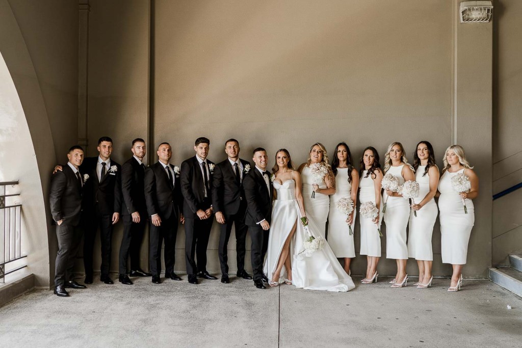 bridal party on plain wall