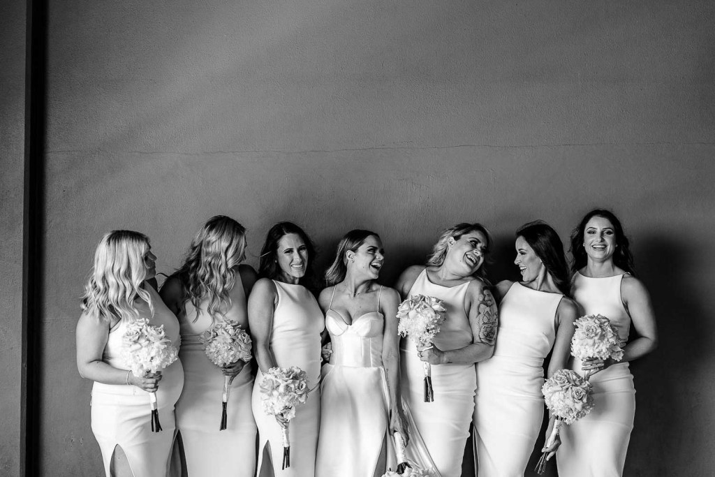 bridesmaids laughing together black and white
