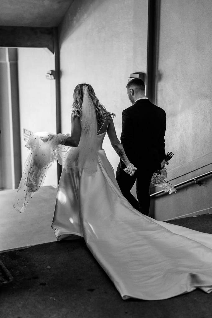 couple walk down stairs black and white