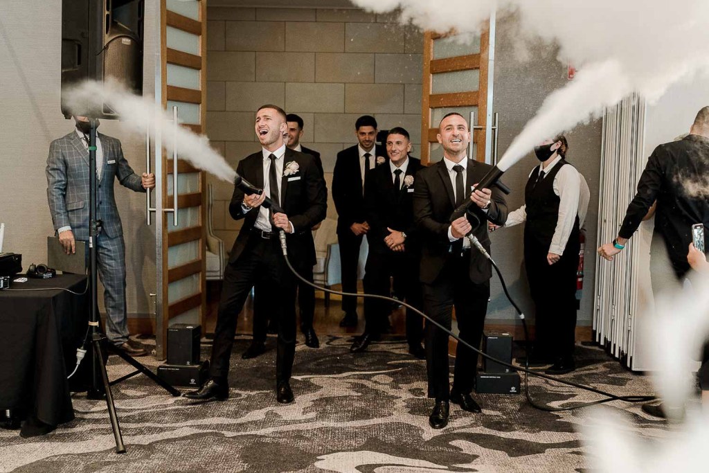 men spraying smoke guns