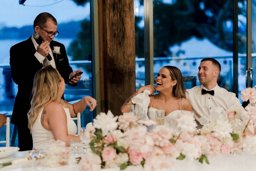 man giving speech with people laughing
