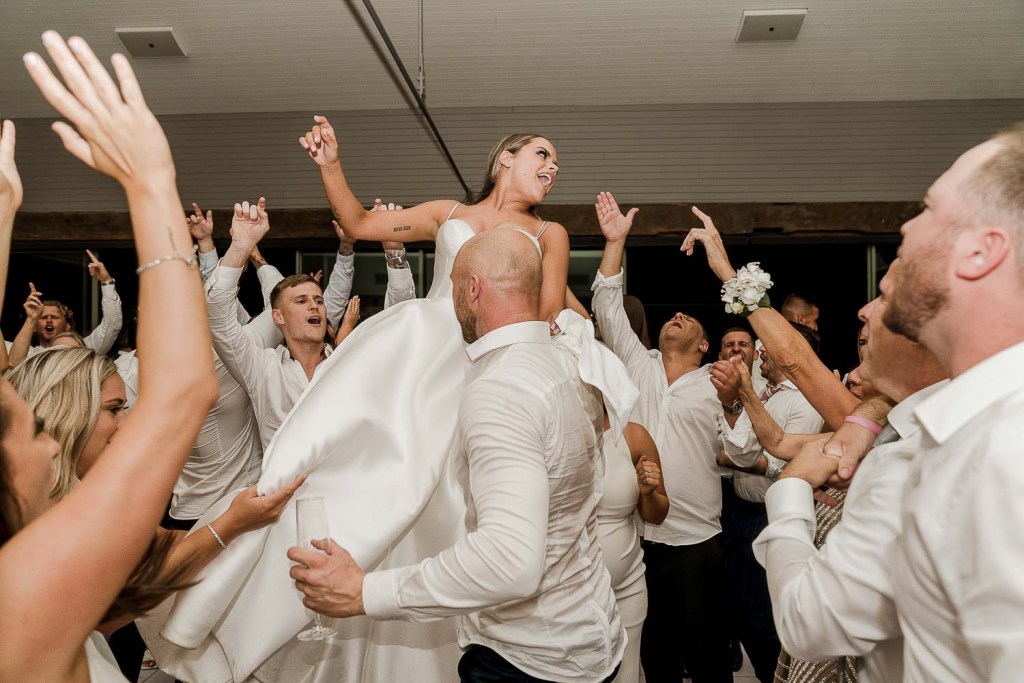 bride lifted in air by men