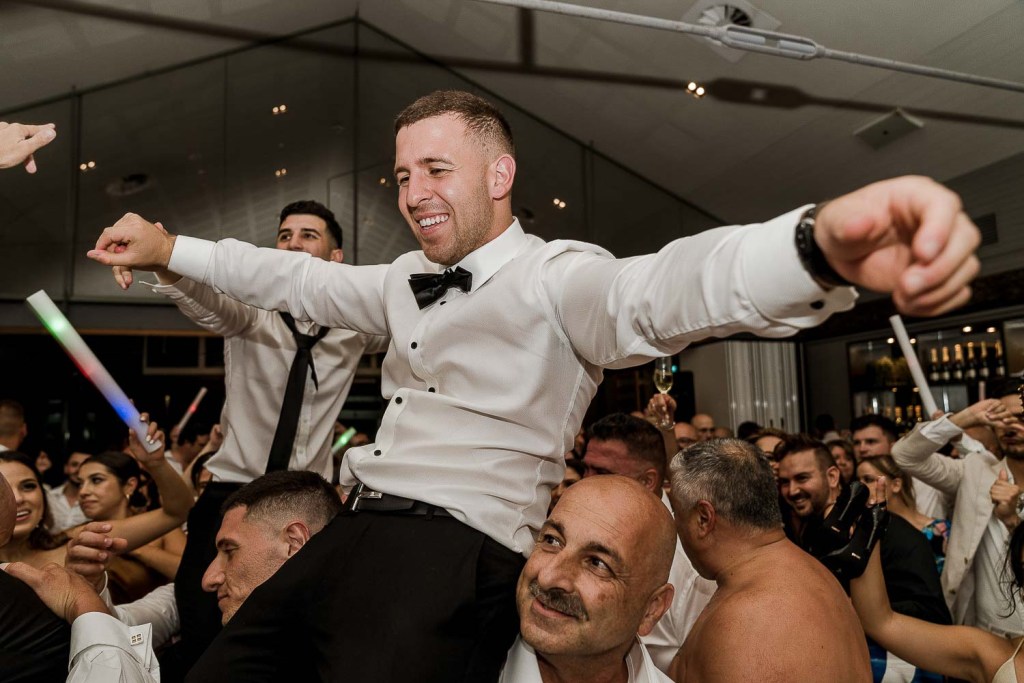 smiling guy lifted on shoulders