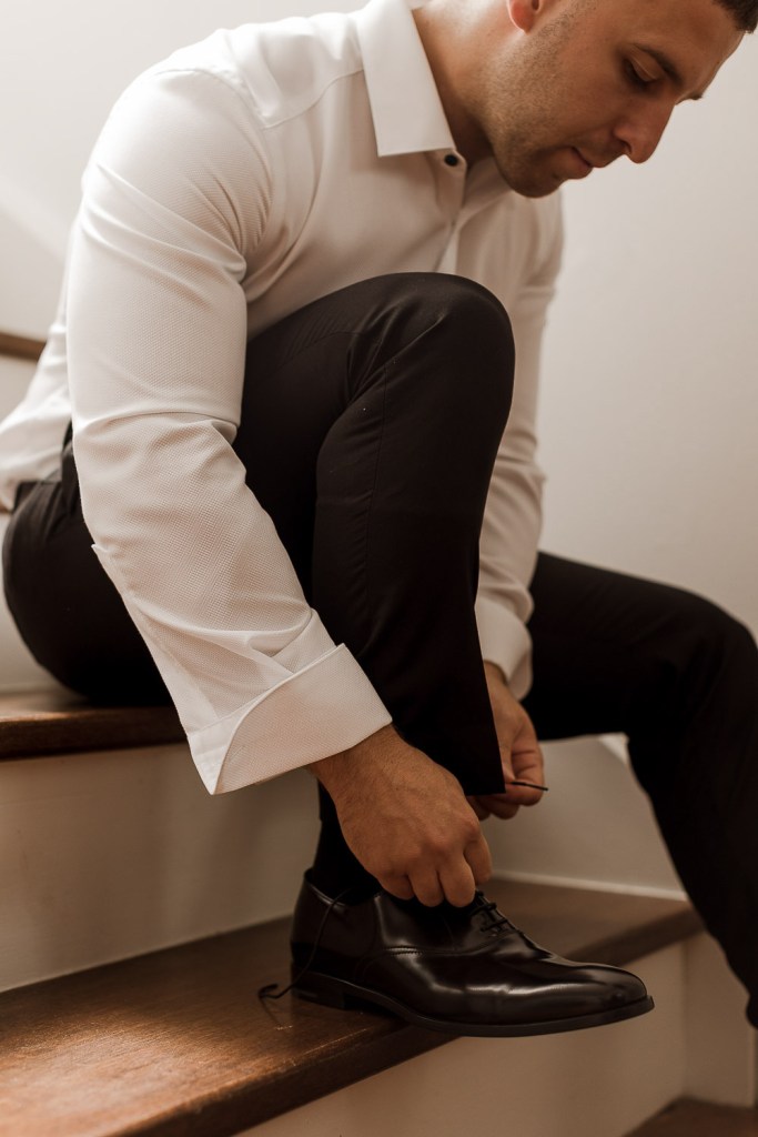 groom tying his shoes