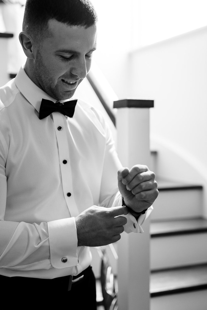 groom fixing shirt