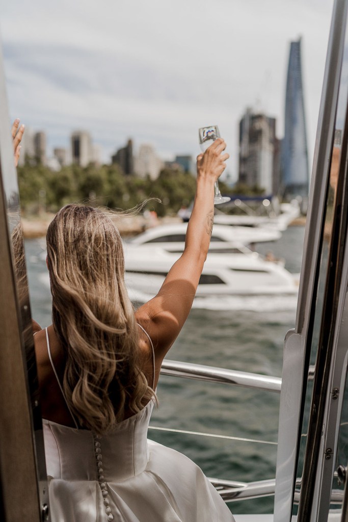 bride waving at boat