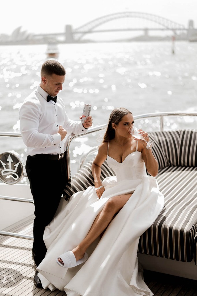 bride and groom glancing ahead on baot