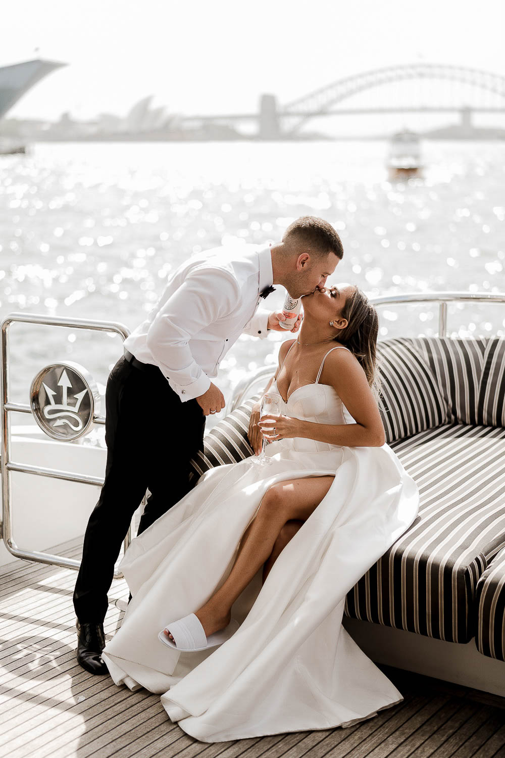 bride and groom kiss on boat