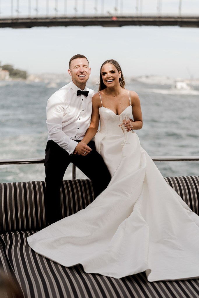 bride and groom smile at camera