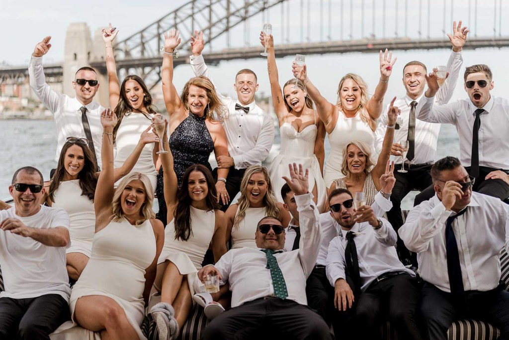 excited group of friends infront of harbour bridge